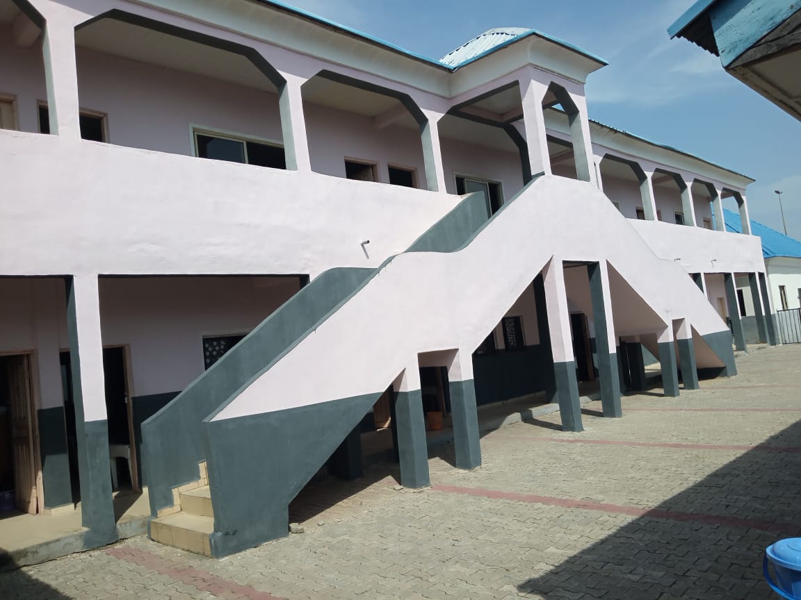 Another view of school building with pink walls and grey stairs